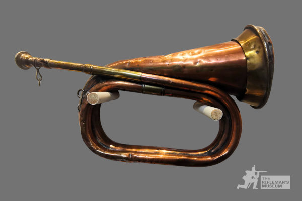 An image of a 19th-century brass bugle held at The Rifleman's Museum.